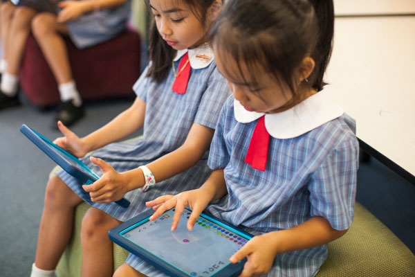 Two students using tablets for enriched learning