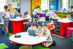 Students working together in various ways inside a modern classroom