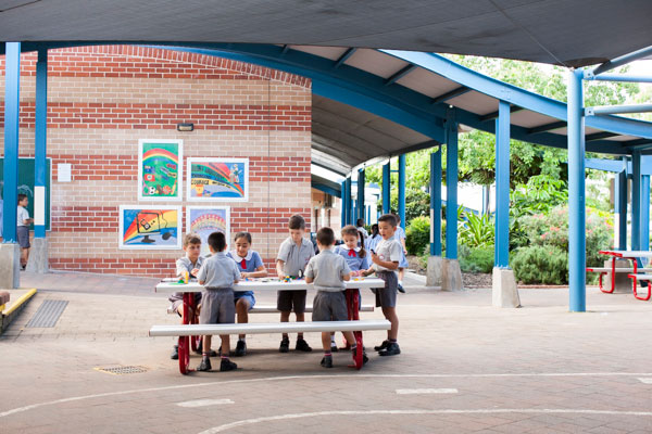 Students building with blocks at a table in COLA